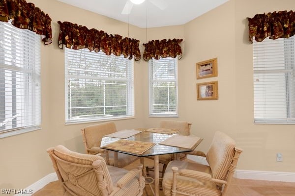 dining room with ceiling fan and light tile patterned flooring