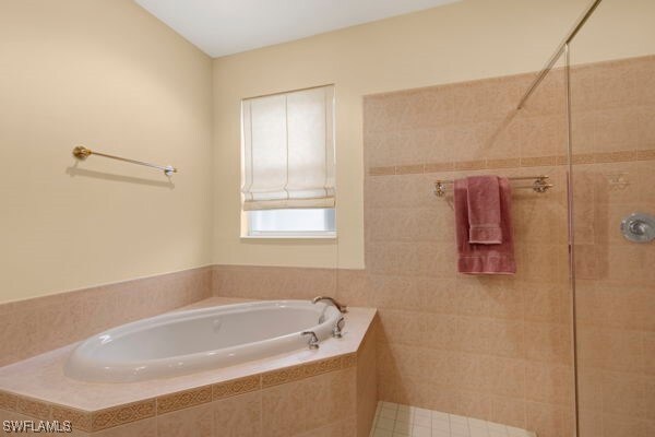 bathroom featuring separate shower and tub