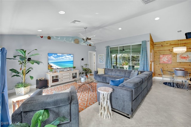 living room featuring vaulted ceiling, ceiling fan, and wood walls