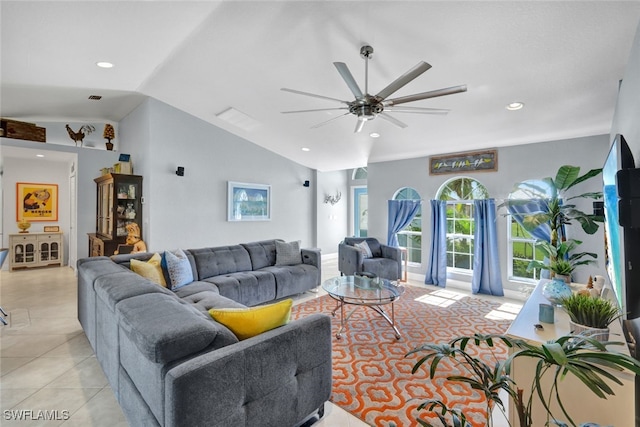 tiled living room with ceiling fan and lofted ceiling