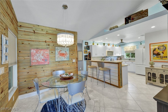 tiled dining space with wood walls