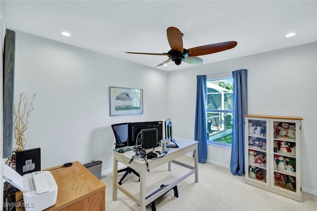 home office with ceiling fan and light carpet