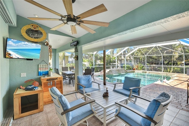 exterior space with ceiling fan, glass enclosure, and a patio