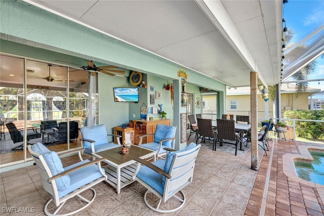 view of patio featuring ceiling fan, a swimming pool, and glass enclosure