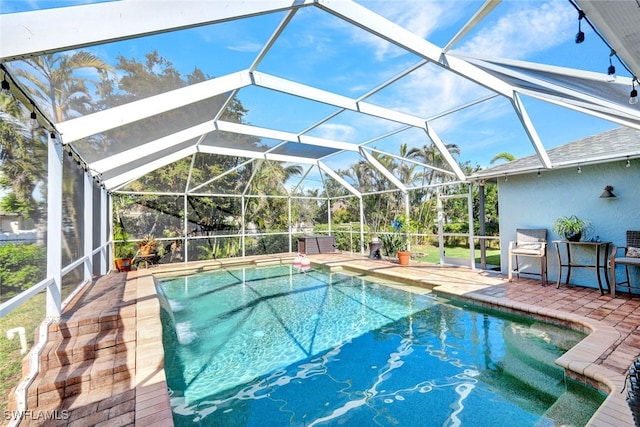 view of pool with a patio and a lanai