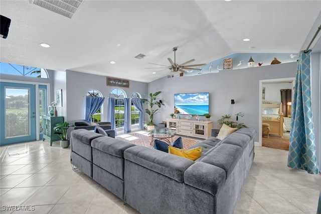 tiled living room featuring french doors, ceiling fan, and vaulted ceiling