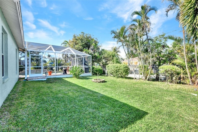 view of yard with glass enclosure