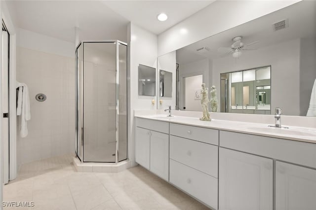 bathroom featuring ceiling fan, vanity, an enclosed shower, and tile patterned floors