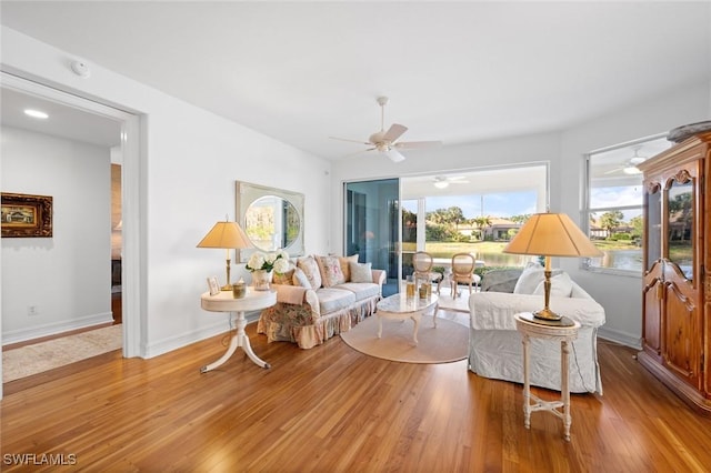 living room featuring ceiling fan and light wood-type flooring