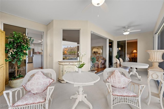 sunroom featuring ceiling fan