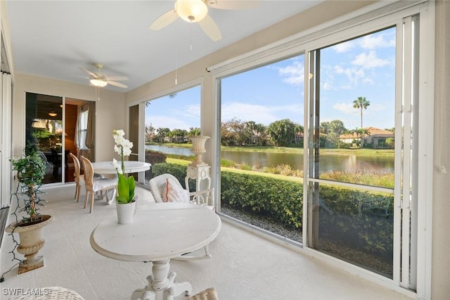 sunroom / solarium with a water view, ceiling fan, and plenty of natural light