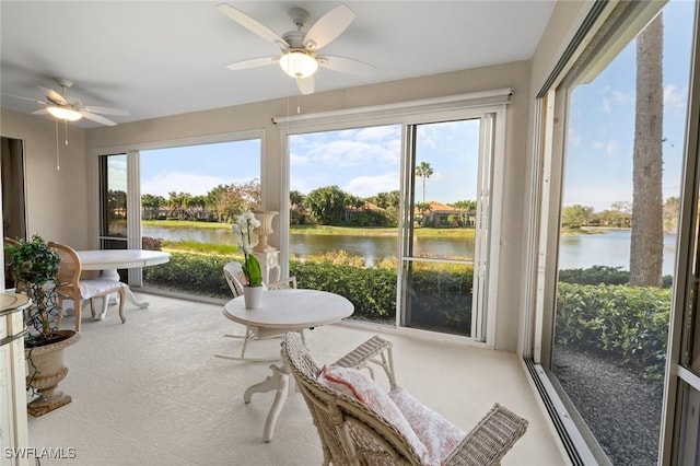 sunroom with a water view, ceiling fan, and plenty of natural light