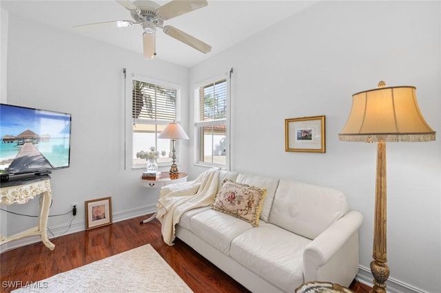 living room with dark wood-type flooring and ceiling fan