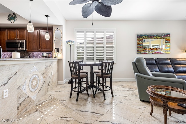 interior space with ceiling fan