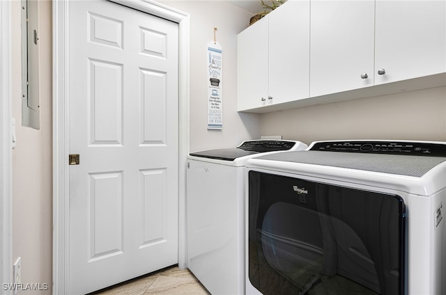 washroom with washer and clothes dryer, light tile patterned floors, and cabinets