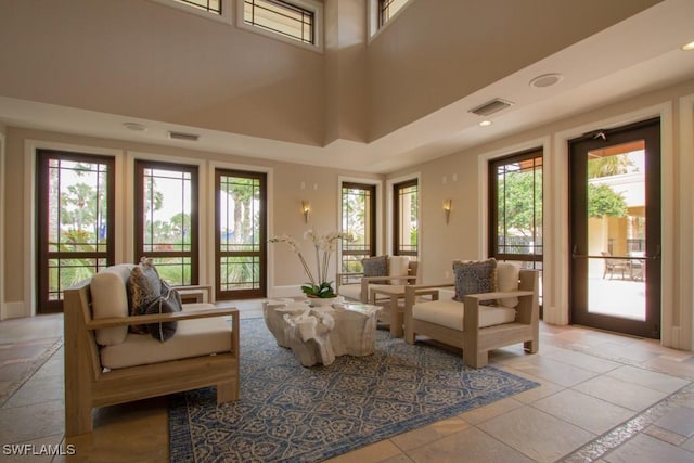 interior space featuring plenty of natural light and a towering ceiling