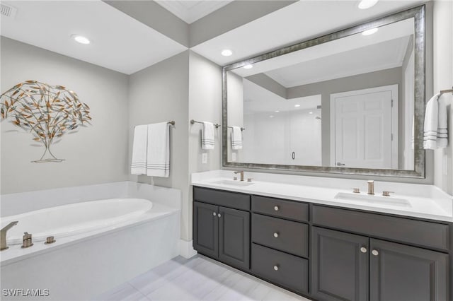 bathroom with a washtub, vanity, crown molding, and tile patterned flooring