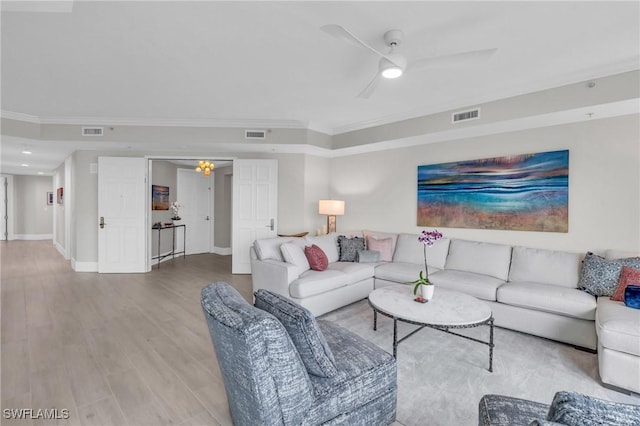 living room with ceiling fan, light wood-type flooring, and crown molding