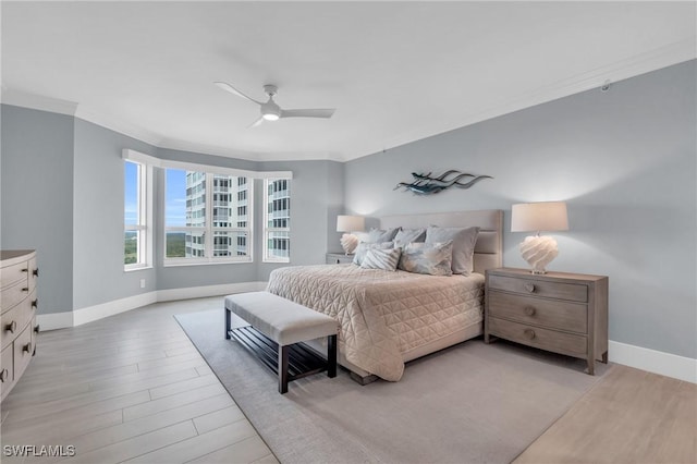 bedroom featuring light wood-type flooring, ceiling fan, and crown molding