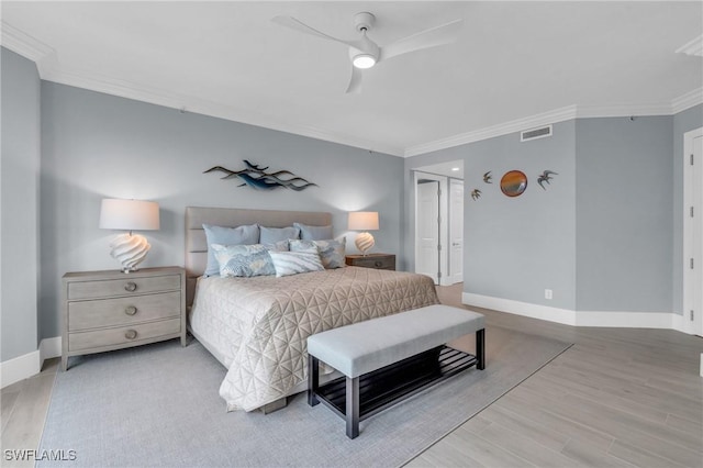 bedroom featuring ceiling fan, light hardwood / wood-style flooring, and ornamental molding