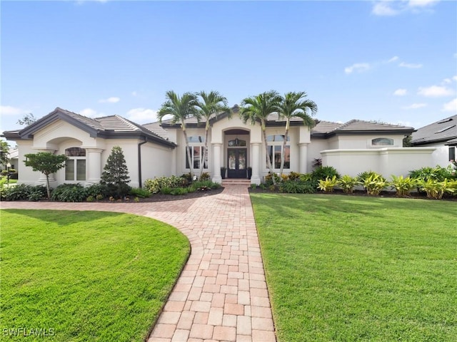 mediterranean / spanish-style house featuring a front lawn