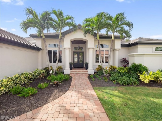 doorway to property with a yard