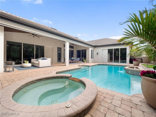 view of swimming pool with an outdoor living space, an in ground hot tub, a patio area, and ceiling fan