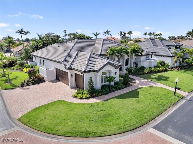 view of front of house featuring a garage and a front yard