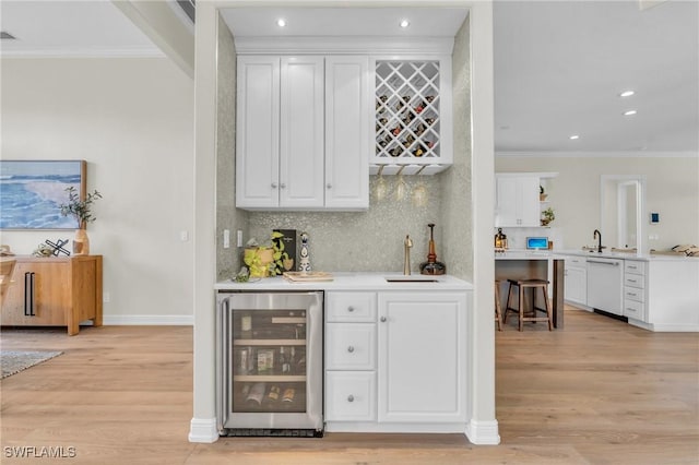 bar with white cabinetry, white dishwasher, crown molding, and wine cooler