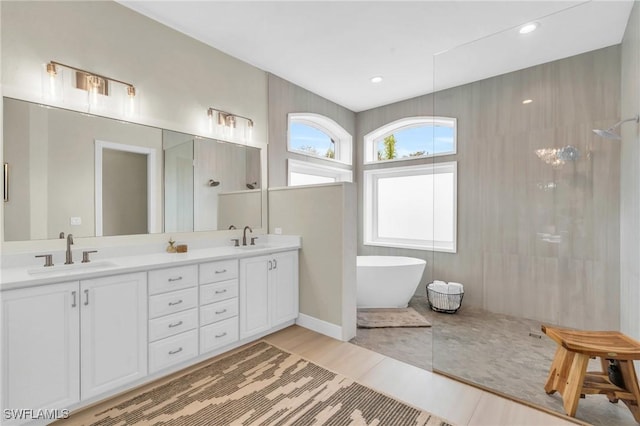 bathroom featuring vanity and plus walk in shower