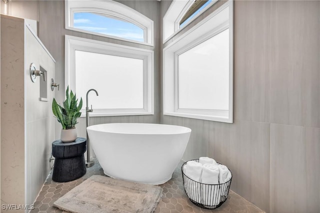 bathroom with a tub to relax in