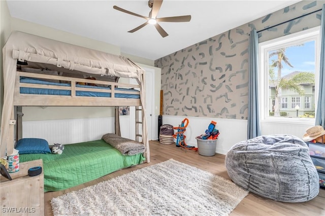 bedroom with ceiling fan and hardwood / wood-style floors