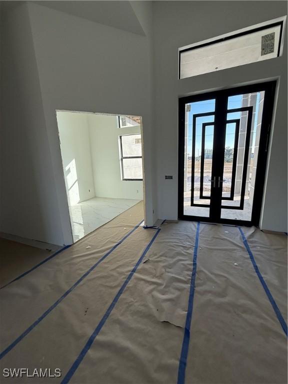 foyer entrance with french doors and a high ceiling