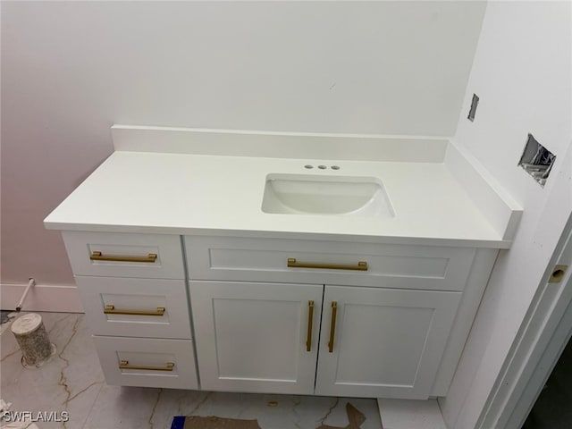 bathroom featuring marble finish floor and vanity