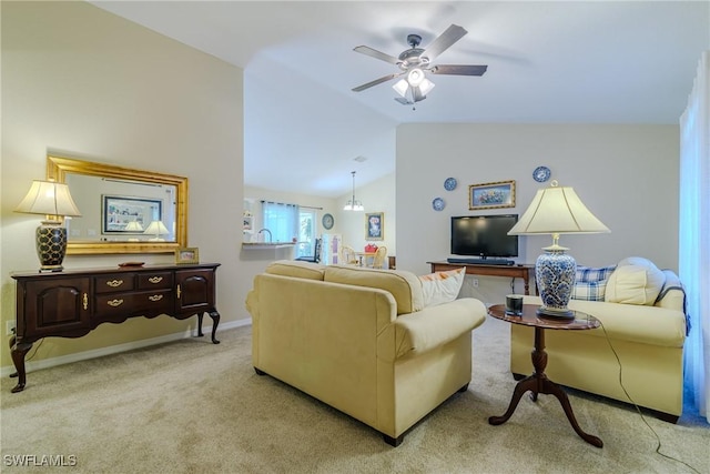 living room featuring vaulted ceiling, light colored carpet, and ceiling fan