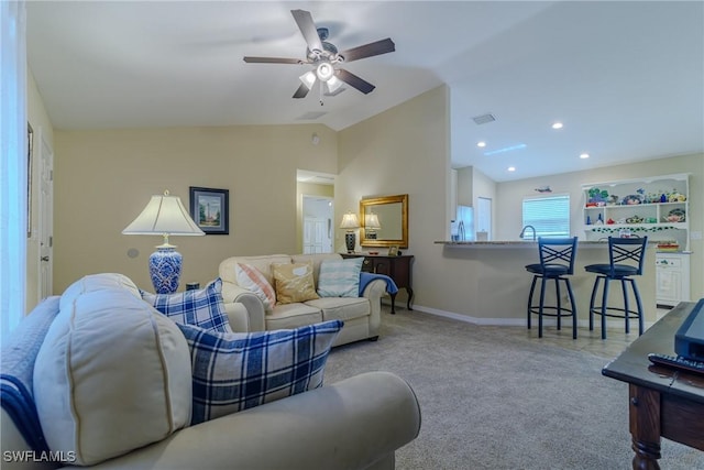 living room with ceiling fan, sink, vaulted ceiling, and light carpet