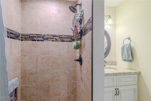 bathroom featuring vanity and a tile shower