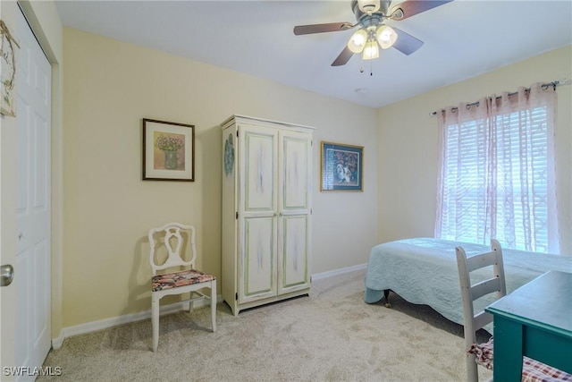 bedroom featuring light colored carpet and ceiling fan