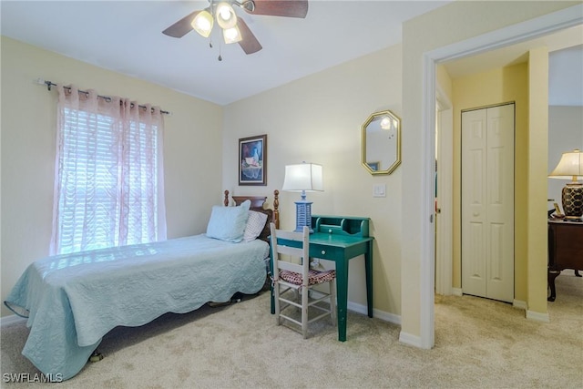 bedroom featuring ceiling fan and light colored carpet