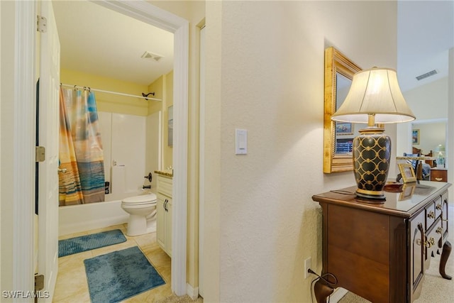 interior space featuring toilet, vanity, shower / bathtub combination with curtain, and tile patterned flooring