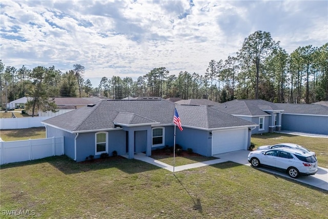 view of front of home with a garage and a front yard