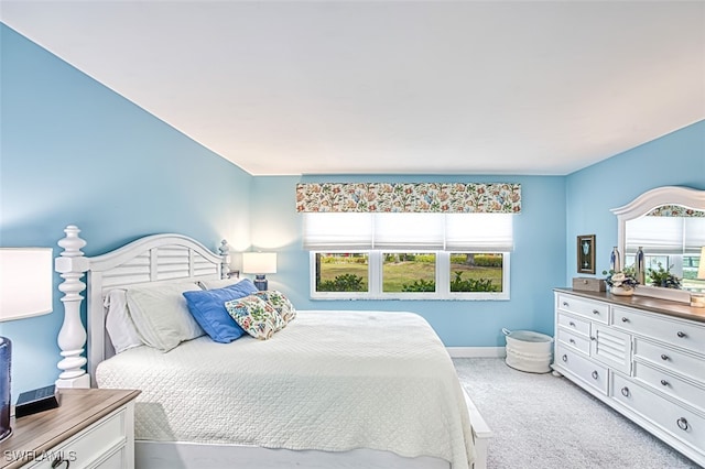 carpeted bedroom with baseboards