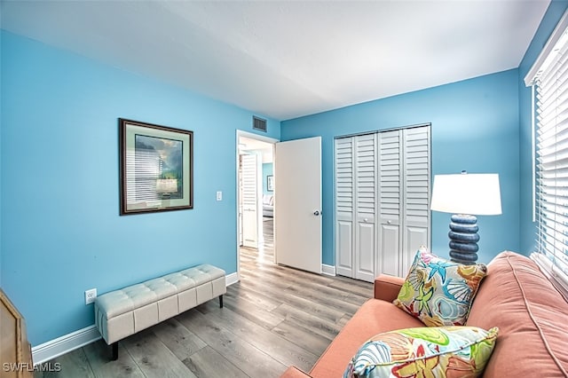 interior space with wood finished floors, visible vents, and baseboards