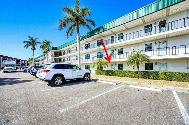 view of building exterior featuring uncovered parking