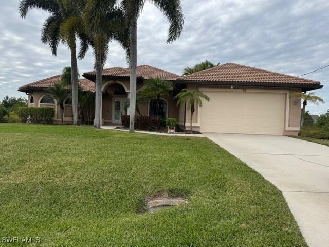 mediterranean / spanish-style house with a garage and a front yard