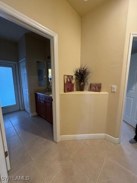 hallway featuring light tile patterned floors