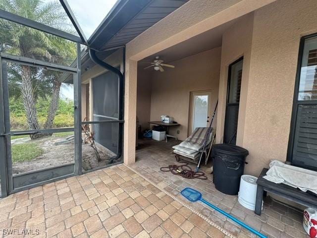 sunroom with ceiling fan