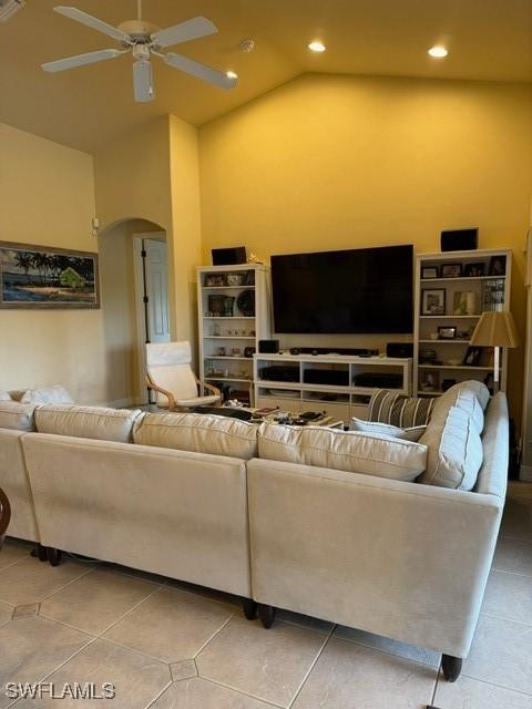 living room with high vaulted ceiling, ceiling fan, and tile patterned flooring