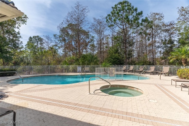 view of pool featuring a patio area and a community hot tub