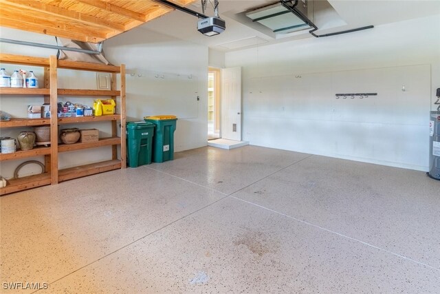 garage featuring a garage door opener and electric water heater